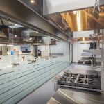 Commercial kitchen and upper dining area at Metro Technology Centers- Culinary Arts Café was designed by Renaissance Architecture.